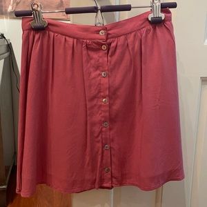 Super cute mini skirt with buttons down the front!